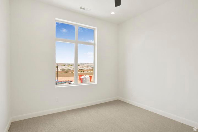 990 Manen Street Washington, UT 84780 - Photo 33 of 43 Bright interior space featuring a large multi-pane window, recessed lighting, ceiling fan, and light-toned carpet flooring