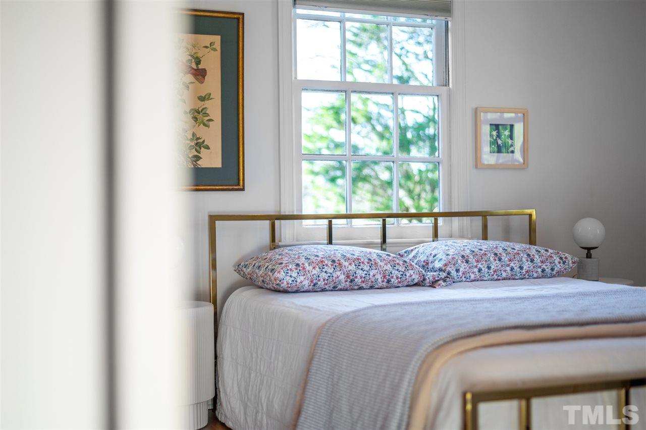 311 Dacian Avenue Durham, NC 27701 - Photo 17 of 30 a bedroom with a large bed and a window