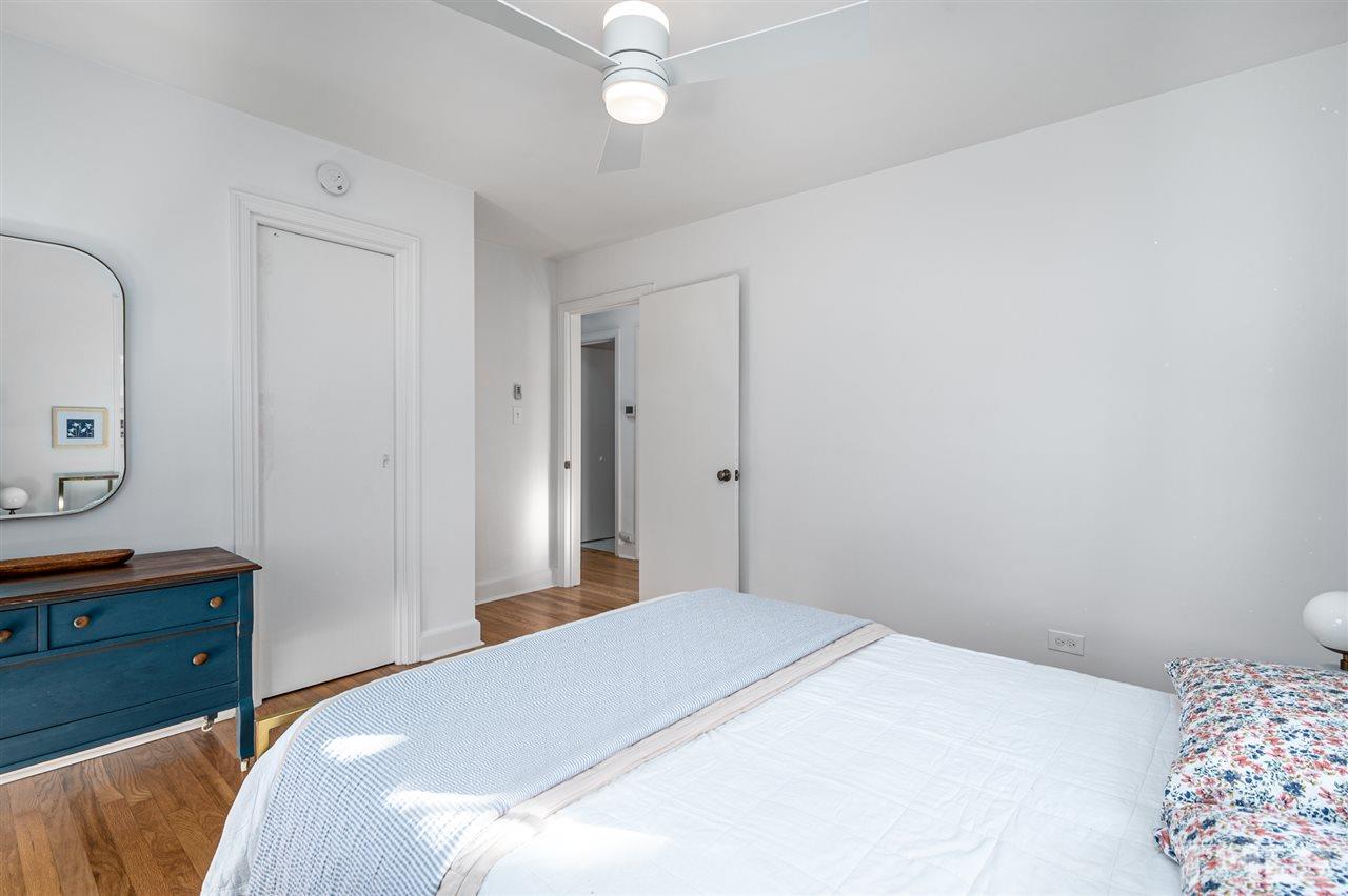 311 Dacian Avenue Durham, NC 27701 - Photo 18 of 30 a bedroom with a bed and a chandelier