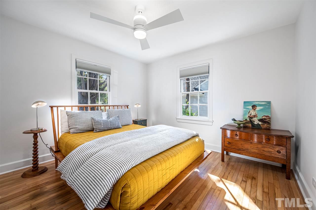 311 Dacian Avenue Durham, NC 27701 - Photo 21 of 30 a bedroom with a bed and wooden floor