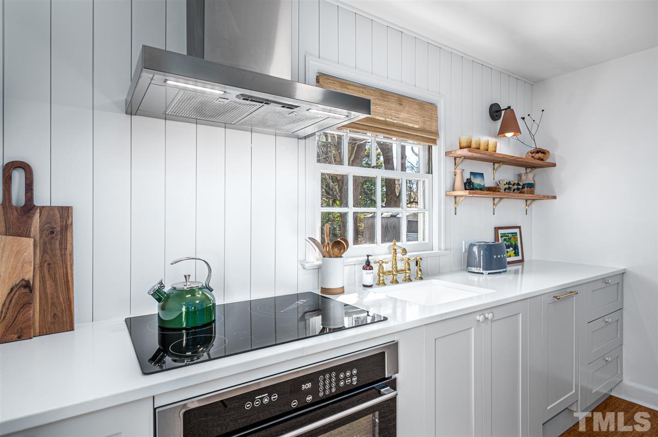 311 Dacian Avenue Durham, NC 27701 - Photo 10 of 30 a kitchen with a refrigerator and a sink