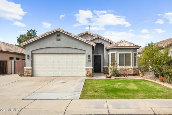 a front view of a house with a yard and outdoor seating