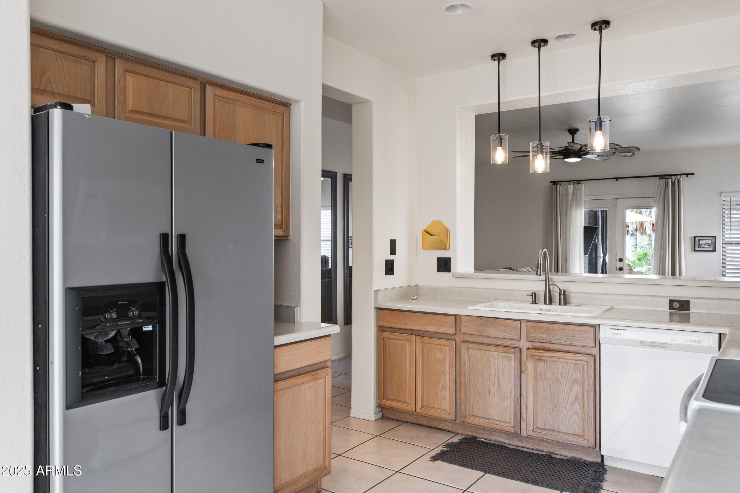 1140 South Rockwell Street Gilbert, AZ 85296 - Photo 11 of 29 a kitchen with white cabinets and refrigerator