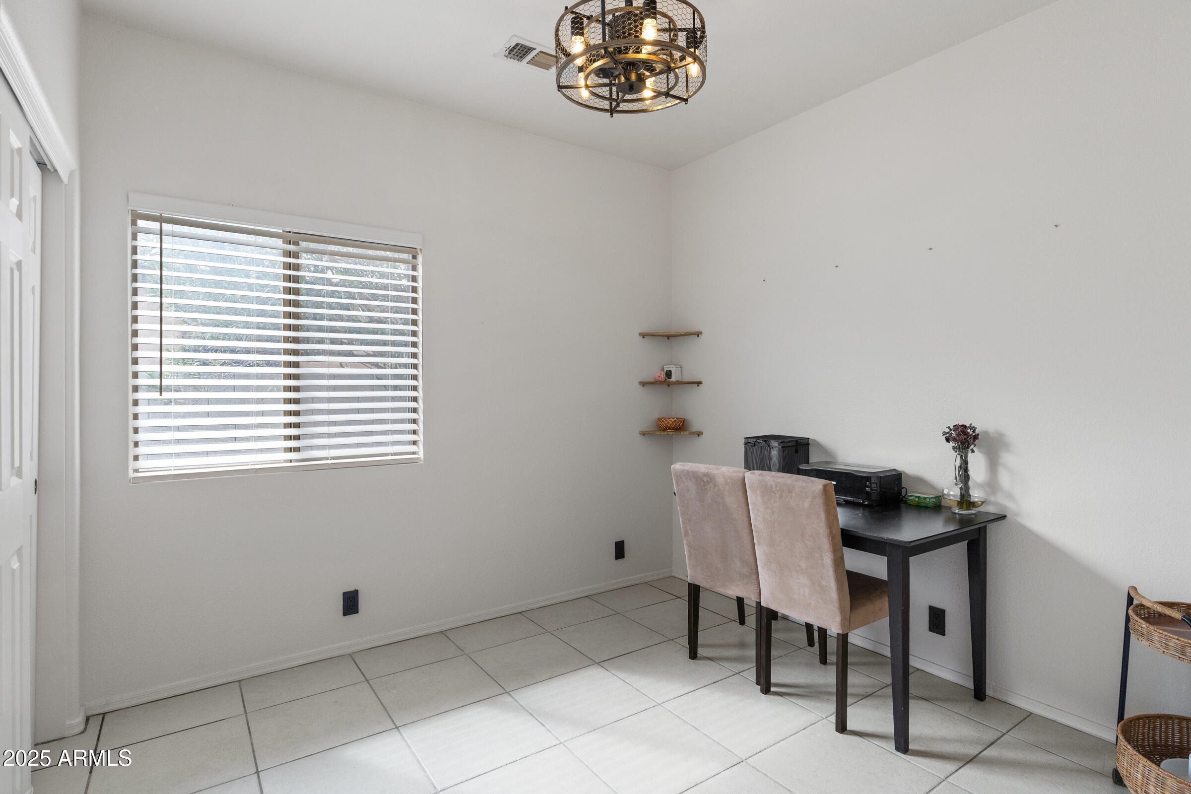 1140 South Rockwell Street Gilbert, AZ 85296 - Photo 15 of 29 a view of a room that has a window and a table in it
