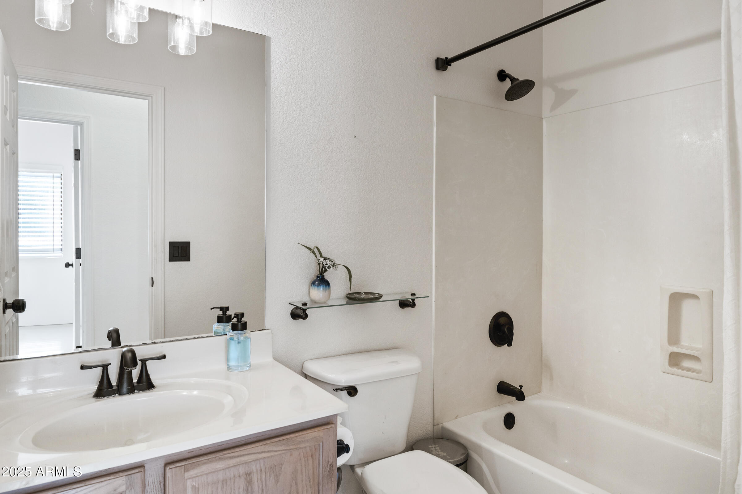 1140 South Rockwell Street Gilbert, AZ 85296 - Photo 16 of 29 a bathroom with a sink a toilet and a mirror