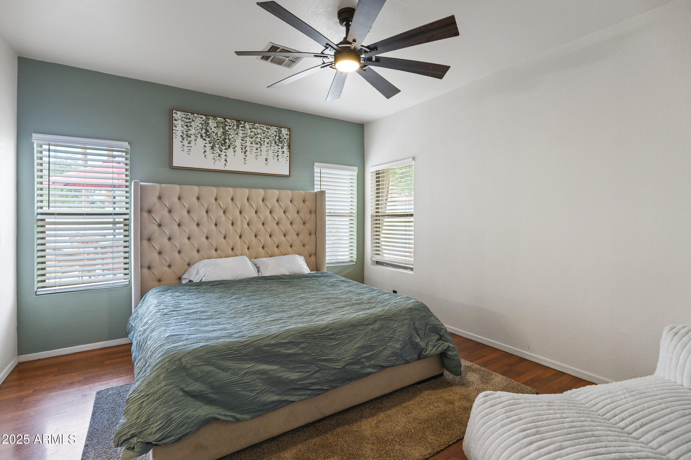 1140 South Rockwell Street Gilbert, AZ 85296 - Photo 18 of 29 a bedroom with a bed and a chandelier