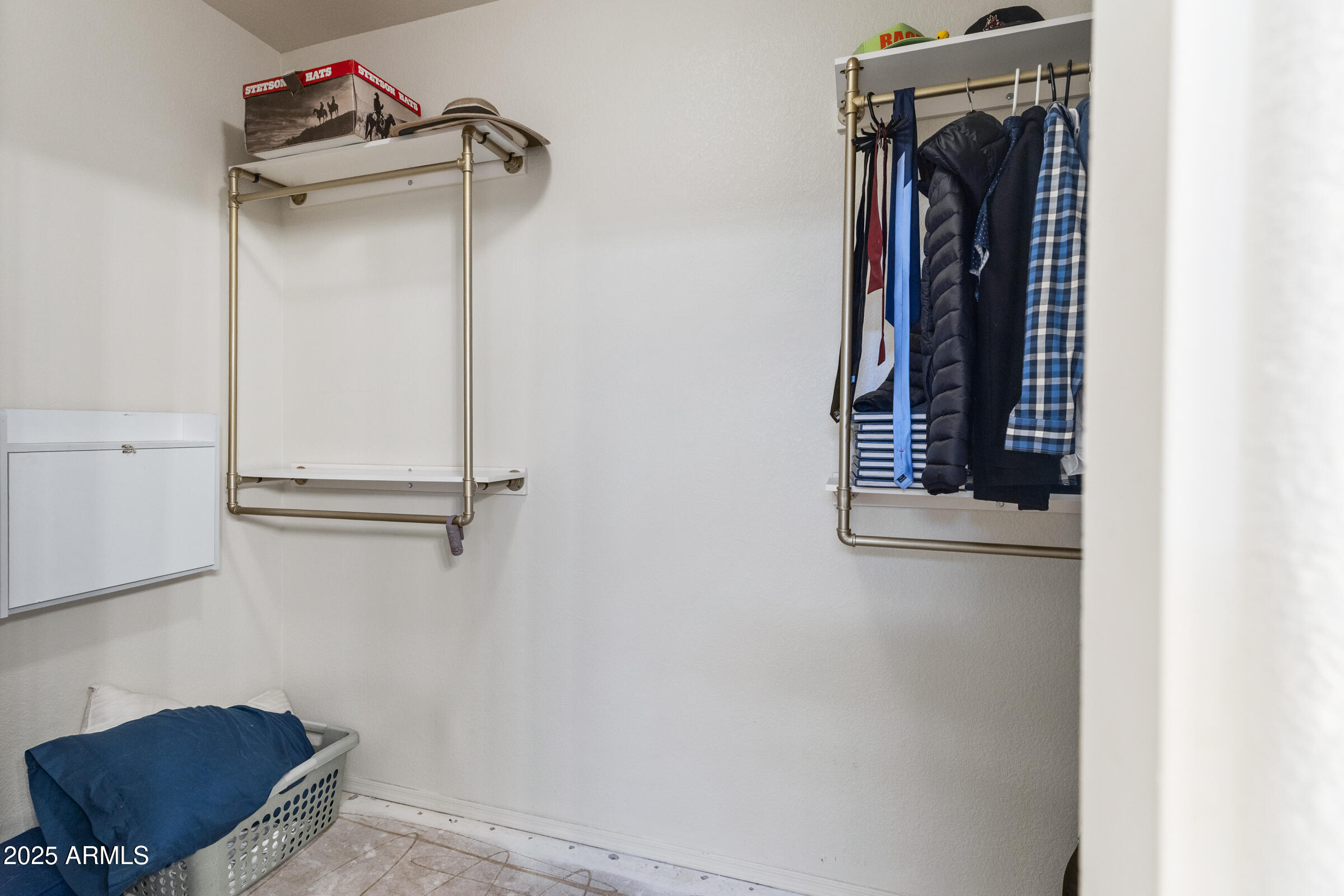 1140 South Rockwell Street Gilbert, AZ 85296 - Photo 22 of 29 a view of walk in closet with clothes and shoes