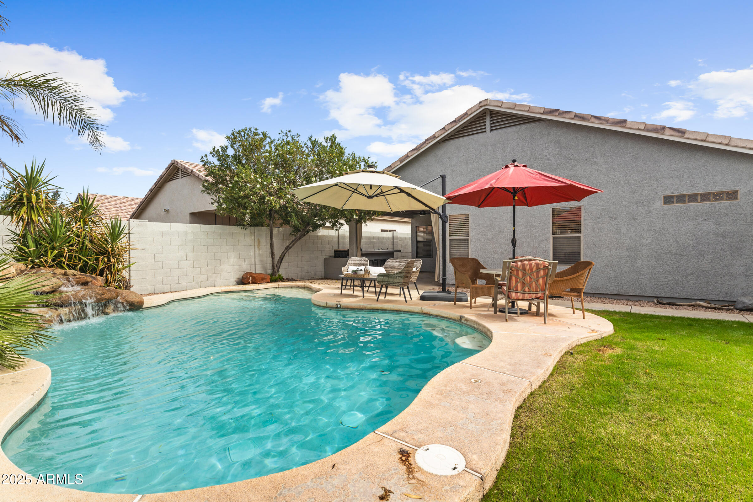 1140 South Rockwell Street Gilbert, AZ 85296 - Photo 27 of 29 a view of a swimming pool with lounge chairs