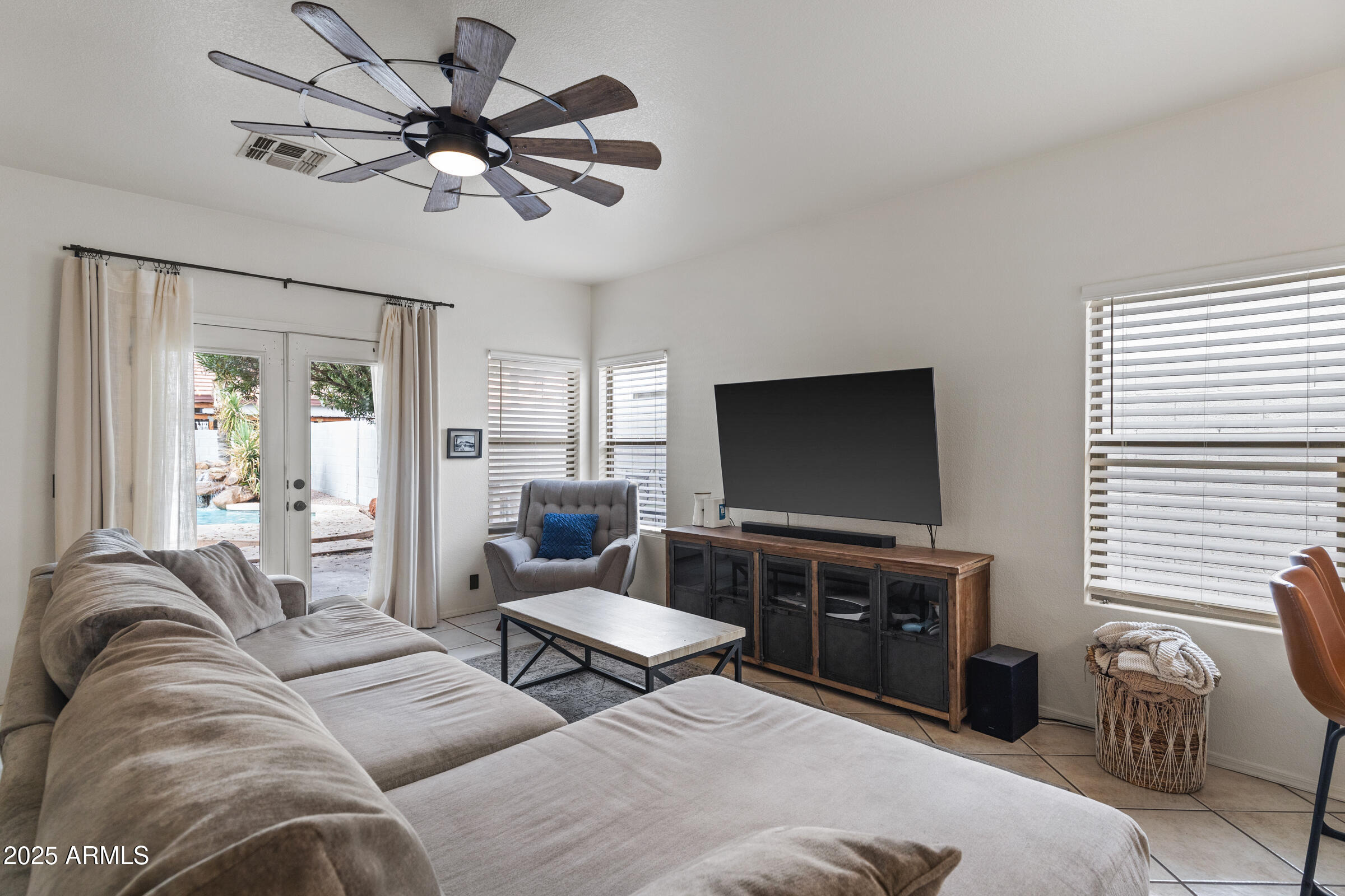 1140 South Rockwell Street Gilbert, AZ 85296 - Photo 5 of 29 a living room with furniture and a flat screen tv