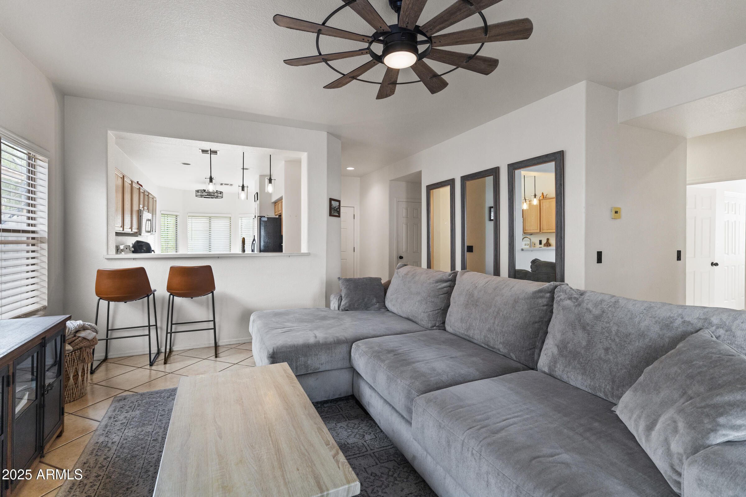 1140 South Rockwell Street Gilbert, AZ 85296 - Photo 6 of 29 a living room with furniture and a large window