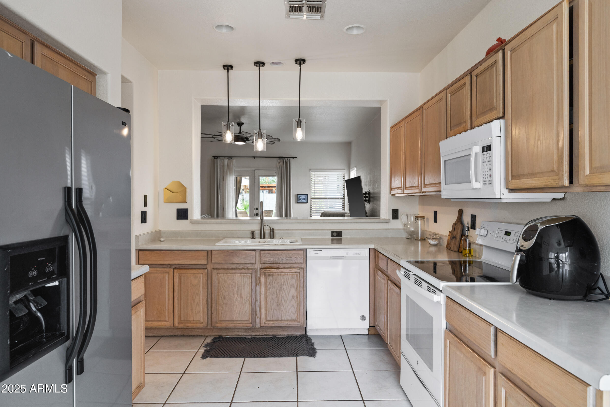 1140 South Rockwell Street Gilbert, AZ 85296 - Photo 10 of 29 a kitchen with a sink a stove a refrigerator and cabinets