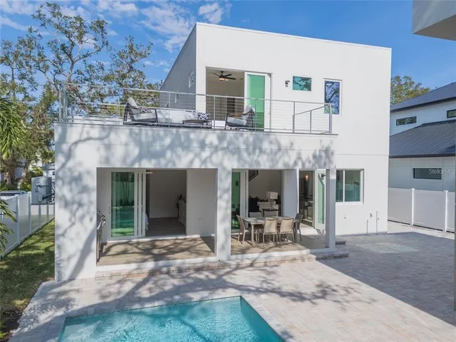 a spacious bathroom with double vanity a toilet a sink and mirror