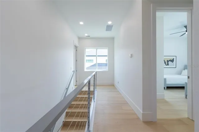 a view of yard from deck with patio