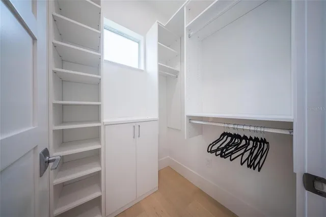 a bedroom with a large bed and a large window