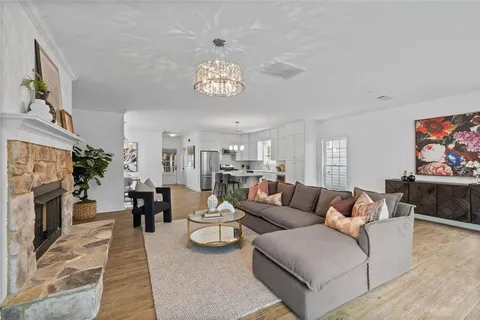 a living room with fireplace furniture and a wooden floor