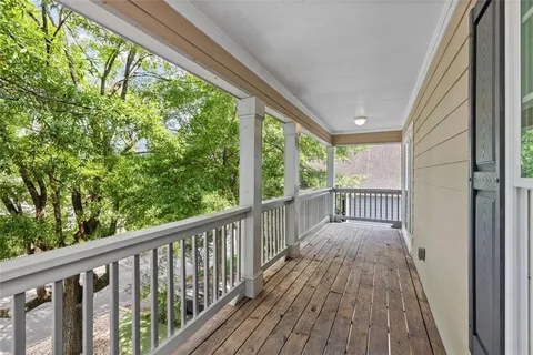 a view of balcony with wooden floor