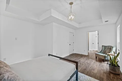 a bedroom with a bed and a chandelier