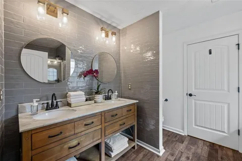 a bathroom with a double vanity sink and a mirror