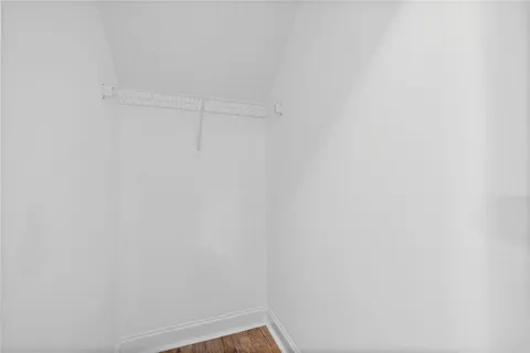 a view of a room with wooden floor and a window