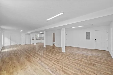 a kitchen with a refrigerator and white cabinets
