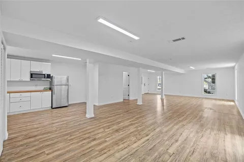 a kitchen with granite countertop white cabinets and a window