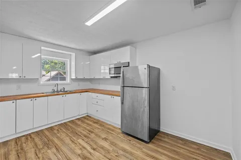 a bathroom with a granite countertop toilet a sink and bathtub