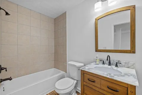 a bedroom with furniture and a wooden floor