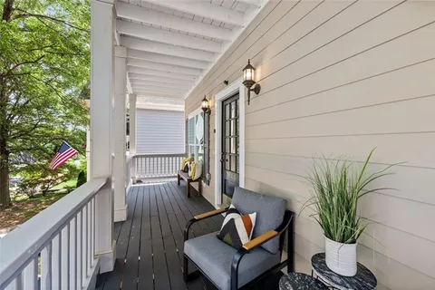 a view of balcony with furniture and wooden floor