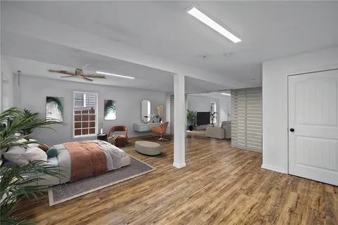 a living room with furniture a rug and kitchen view