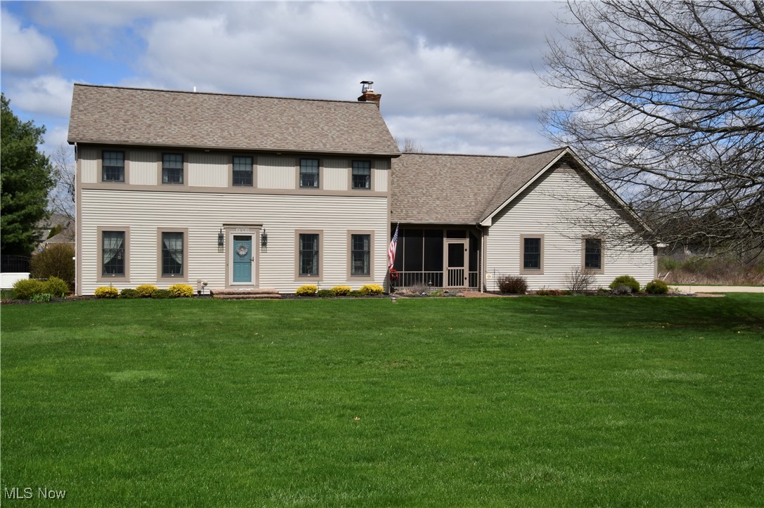 3180 West Calla Road Canfield, OH 44406 - Photo 2 of 49 Colonial-style house with a front yard, a sunroom, a chimney, and a shingled roof