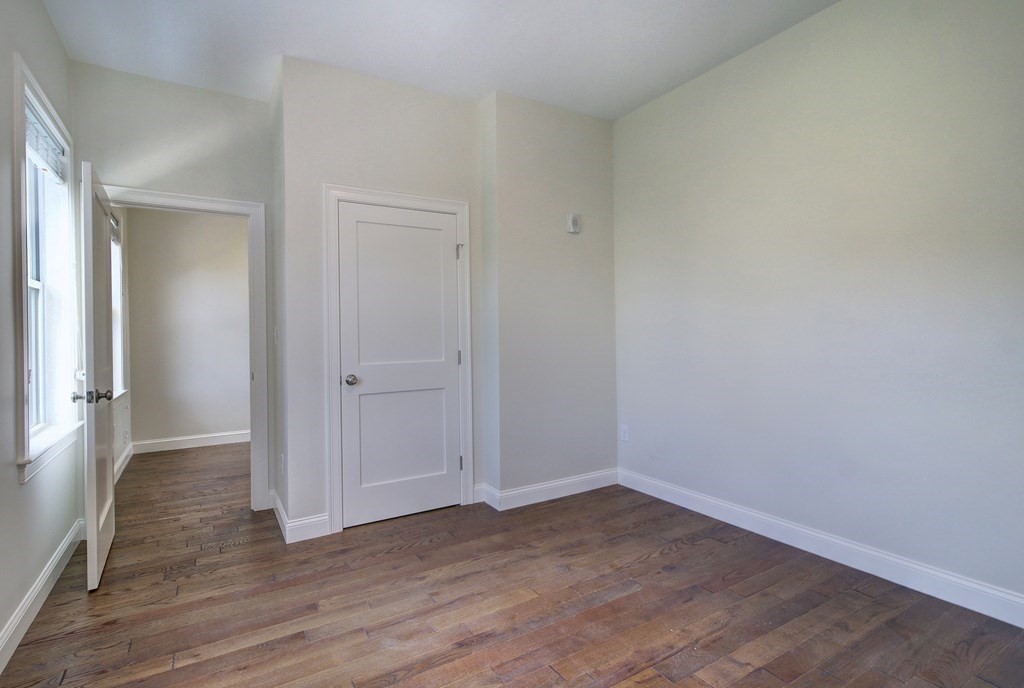 4 Kemp Street, Unit 4 Boston, MA 02127 - Photo 11 of 40 a view of an empty room and wooden floor