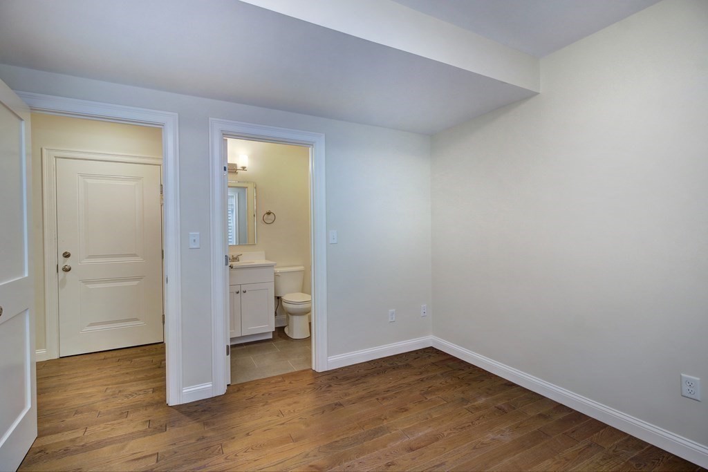 4 Kemp Street, Unit 4 Boston, MA 02127 - Photo 15 of 40 a view of a room with wooden floor and a bathroom