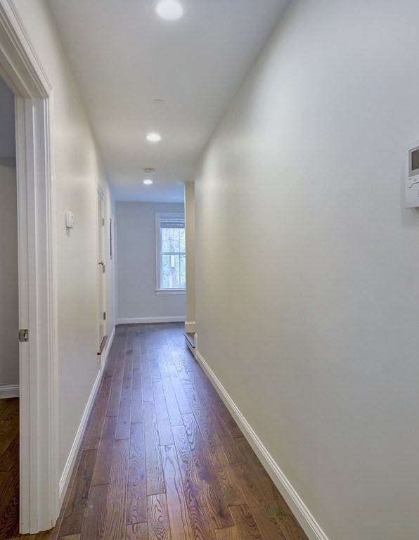 4 Kemp Street, Unit 4 Boston, MA 02127 - Photo 17 of 40 a view of a hallway with wooden floor