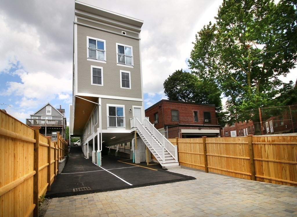 4 Kemp Street, Unit 4 Boston, MA 02127 - Photo 2 of 40 a view of a house with a barbeque and large trees
