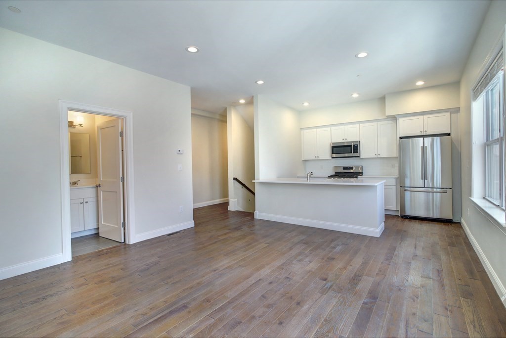 4 Kemp Street, Unit 4 Boston, MA 02127 - Photo 23 of 40 a view of kitchen with stainless steel appliances kitchen island wooden floors and granite counter tops