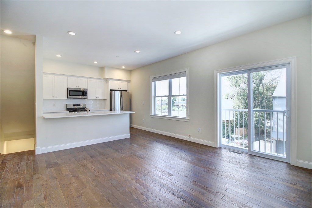 4 Kemp Street, Unit 4 Boston, MA 02127 - Photo 24 of 40 a view of kitchen with kitchen island wooden floor wooden floor and refrigerator