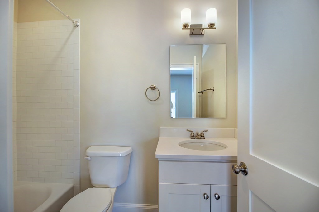 4 Kemp Street, Unit 4 Boston, MA 02127 - Photo 27 of 40 a bathroom with a sink toilet and vanity