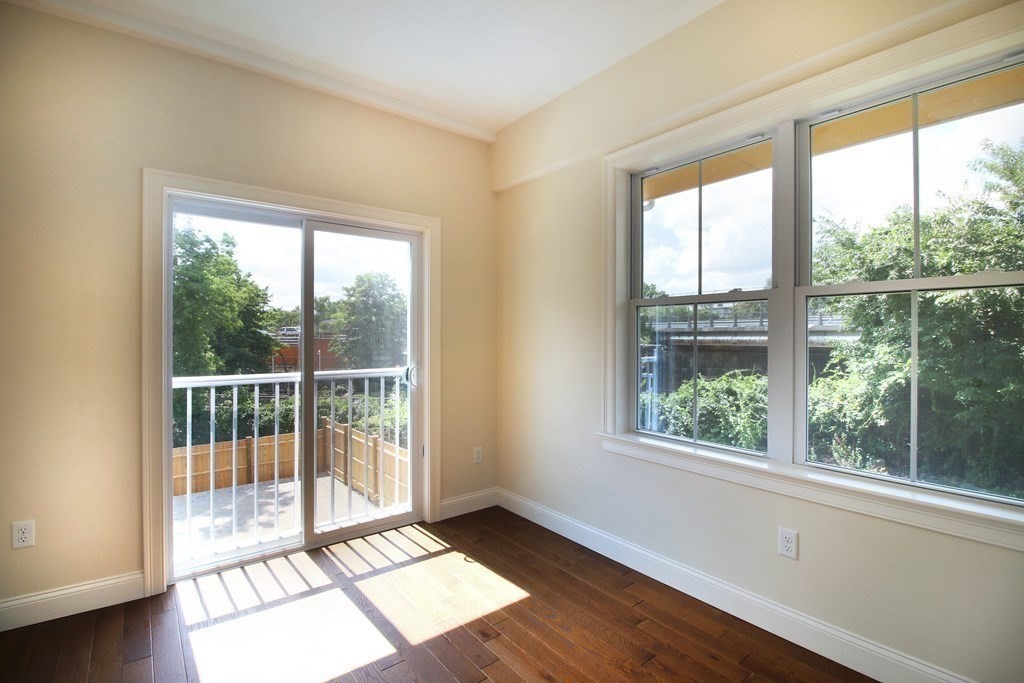 4 Kemp Street, Unit 4 Boston, MA 02127 - Photo 36 of 40 a view of an empty room with wooden floor and a window