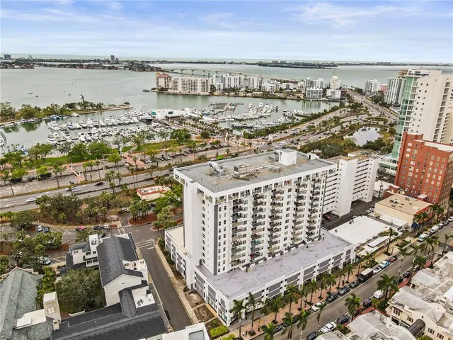 a kitchen with stainless steel appliances granite countertop a refrigerator a stove and a sink with wooden floor