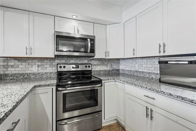 a bedroom with a bed and a mirror on dresser