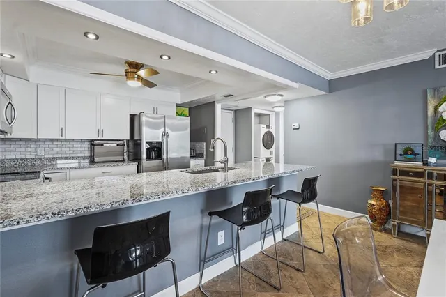 a en suite bathroom with a granite countertop sink and a mirror