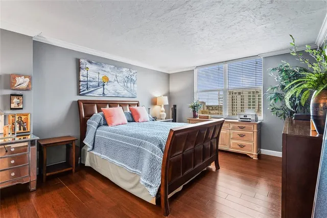 a bathroom with a granite countertop sink toilet mirror and bathtub