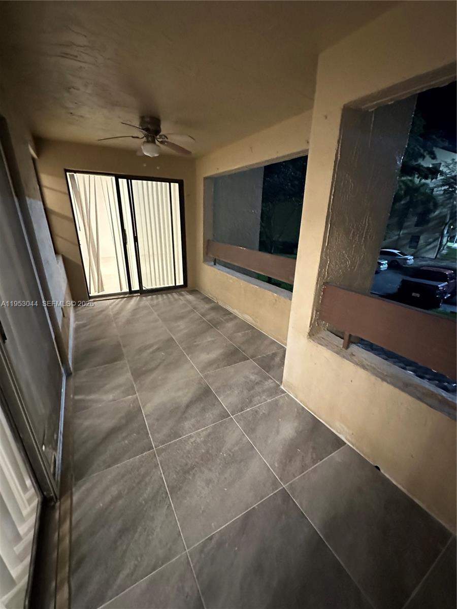 9015 Southwest 125th Avenue, Unit N209 Miami, FL 33186 - Photo 13 of 18 a view of an empty room with a fireplace and a window