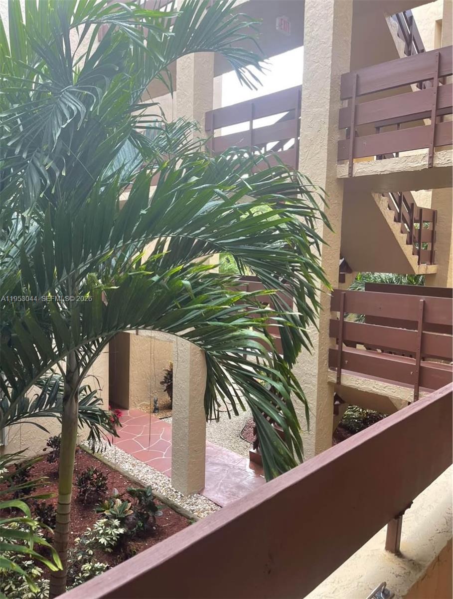 9015 Southwest 125th Avenue, Unit N209 Miami, FL 33186 - Photo 15 of 18 a view of a yard from a balcony