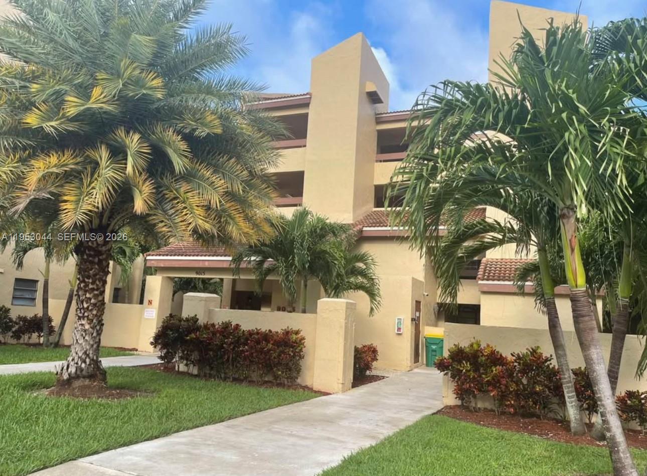 9015 Southwest 125th Avenue, Unit N209 Miami, FL 33186 - Photo 17 of 18 a front view of a house with a garden