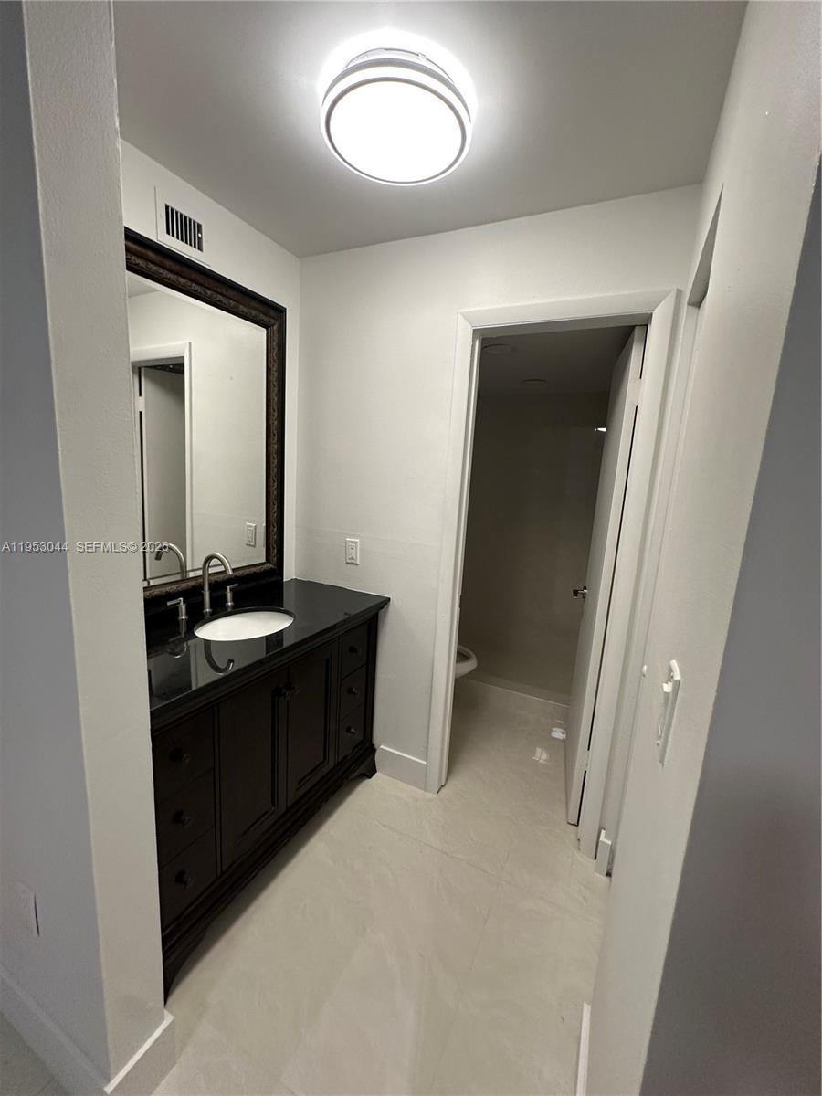 9015 Southwest 125th Avenue, Unit N209 Miami, FL 33186 - Photo 8 of 18 a bathroom with a sink and a mirror