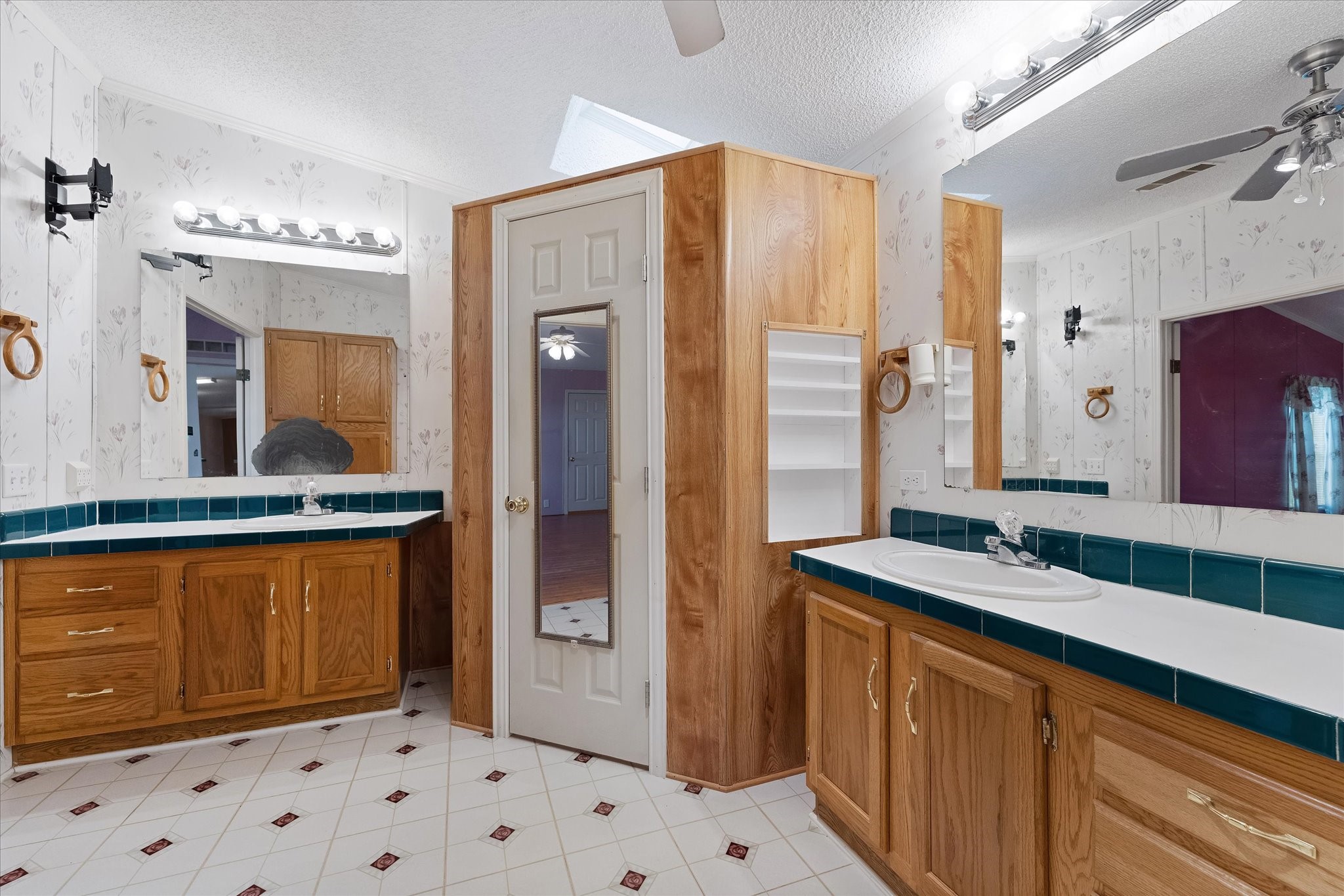 23419 Quiet Hollow Road Montgomery, TX 77356 - Photo 11 of 46 a bathroom with a sink a mirror and a shower