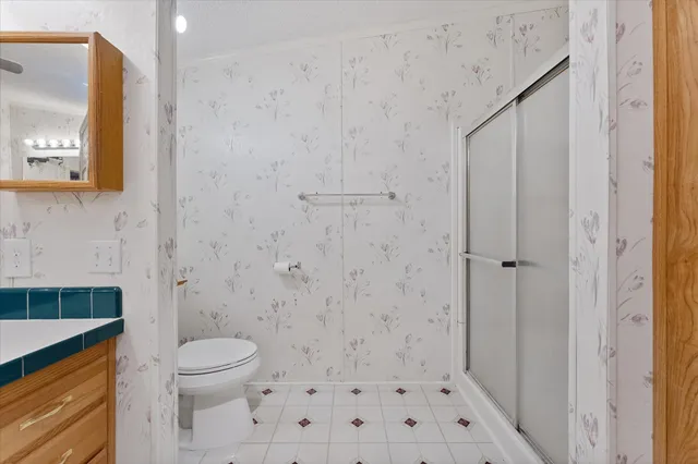 a bathroom with a toilet and a shower