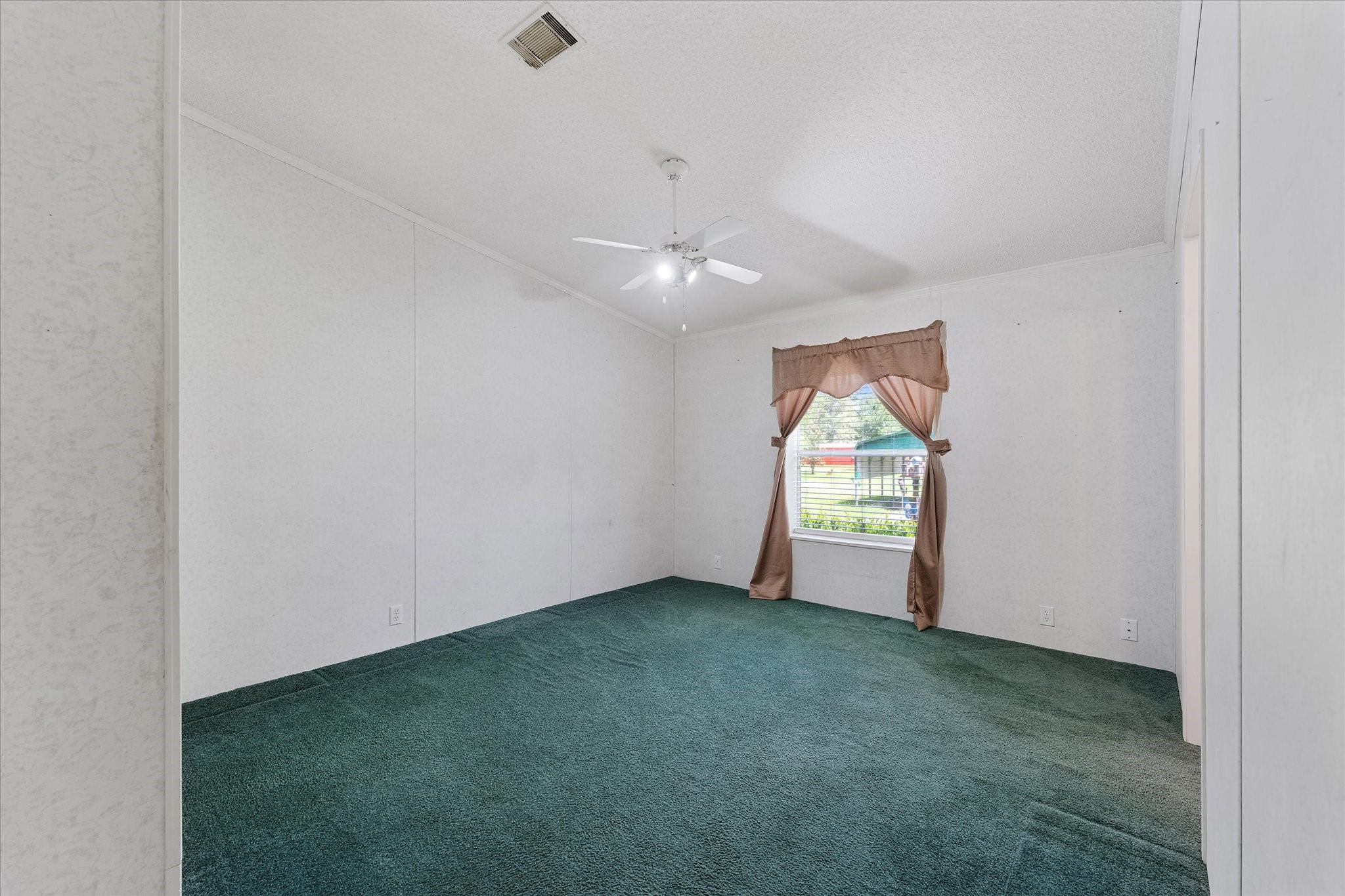 23419 Quiet Hollow Road Montgomery, TX 77356 - Photo 16 of 46 an empty room with windows and fan