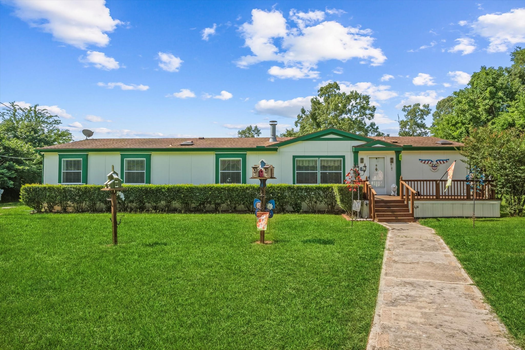 23419 Quiet Hollow Road Montgomery, TX 77356 - Photo 2 of 46 a front view of a house with a yard and garden